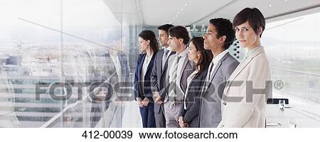 Business people in conference room looking out window View Large Photo Image Stock Photo - Business people in conference room looking out window. Fotosearch