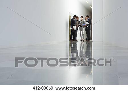 Stock Photo - Business people meeting in corridor. Fotosearch