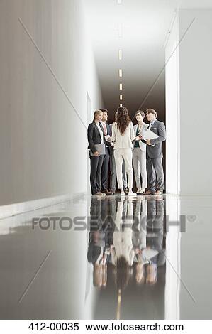 Stock Photography - Business people meeting in corridor. Fotosearch