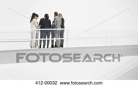 Business people meeting on elevated walkway View Large Photo Image Stock Image - Business people meeting on elevated walkway. Fotosearch