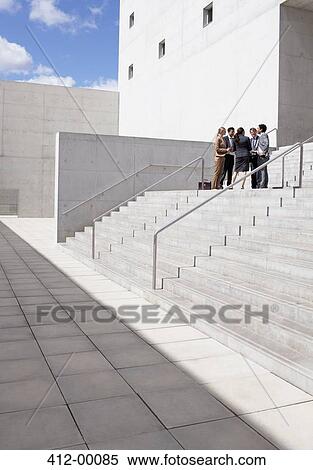 Stock Photography - Business people meeting on urban stairs. Fotosearch