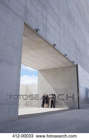 Stock Image - Business people meeting outside modern building. Fotosearch