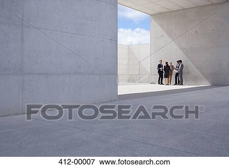 Stock Photo - Business people meeting outside modern building. Fotosearch