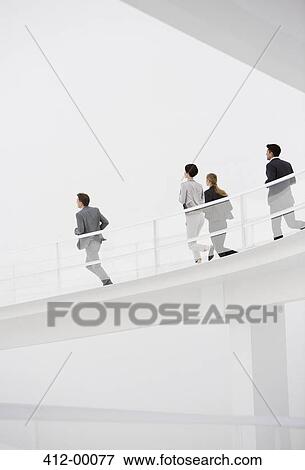 Stock Photo - Business people running down elevated walkway. Fotosearch