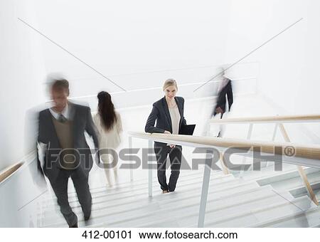 Business people rushing along stairs View Large Photo Image Stock Image - Business people rushing along stairs. Fotosearch