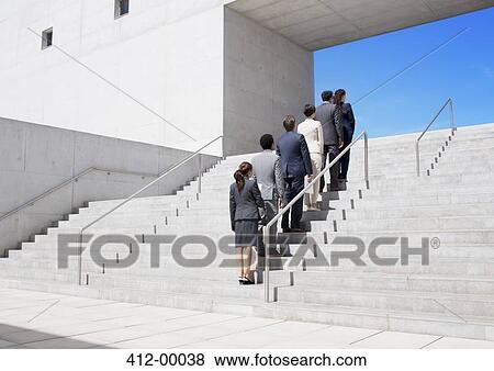 Business people standing in a row on urban stairs View Large Photo Image Stock Photo - Business people standing in a row on urban stairs. Fotosearch