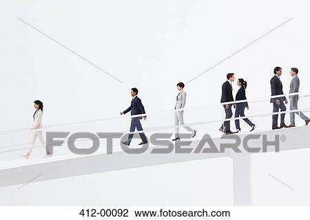 Business people walking down elevated walkway View Large Photo Image Stock Image - Business people walking down elevated walkway. Fotosearch