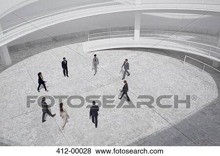 Business people walking in modern courtyard View Large Photo Image Stock Photo - Business people walking in modern courtyard. Fotosearch