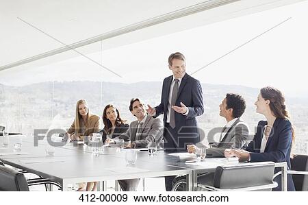 Businessman leading meeting in conference room View Large Photo Image Stock Photo - Businessman leading meeting in conference room. Fotosearch