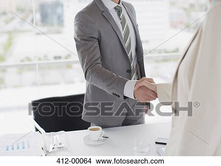 Picture - Businessmen shaking hands. Fotosearch