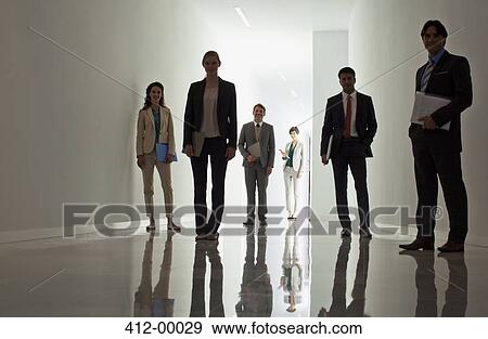 Stock Photo - Portrait of business people in corridor. Fotosearch