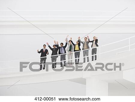 Stock Image - Portrait of cheering business people on elevated walkway. Fotosearch