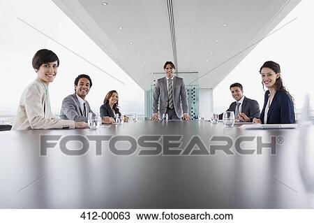 Portrait of smiling business people in conference room View Large Photo Image Stock Image - Portrait of smiling business people in conference room. Fotosearch