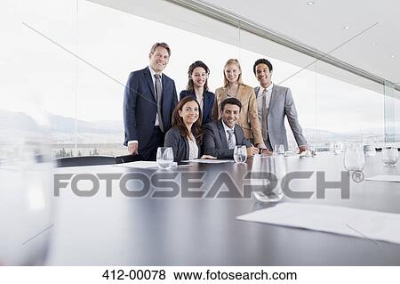 Stock Photo - Portrait of smiling business people in conference room. Fotosearch