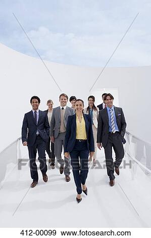 Portrait of smiling business people on walkway View Large Photo Image Stock Photo - Portrait of smiling business people on walkway. Fotosearch