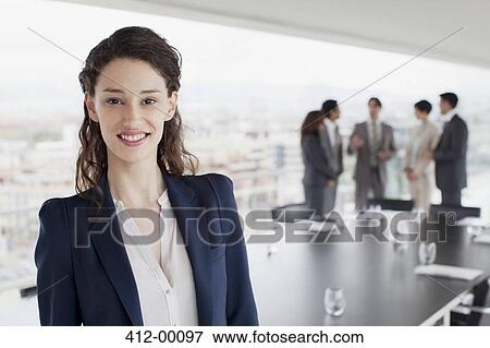 Portrait of smiling businesswoman in conference room View Large Photo Image Stock Photo - Portrait of smiling businesswoman in conference room. Fotosearch