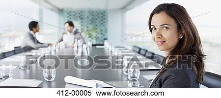 Portrait of smiling businesswoman in conference room View Large Photo Image Stock Photography - Portrait of smiling businesswoman in conference room. Fotosearch