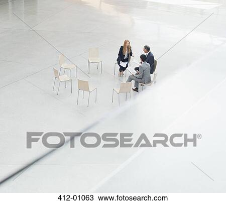 Business people meeting at circle of chairs in lobby View Large Photo Image Stock Image - Business people meeting at circle of chairs in lobby. Fotosearch