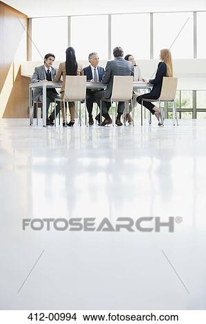 Business people meeting at table in conference room View Large Photo Image Picture - Business people meeting at table in conference room. Fotosearch