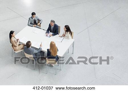 Business people meeting at table View Large Photo Image Stock Photo - Business people meeting at table. Fotosearch