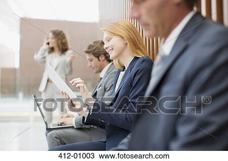 Business people using laptop and digital tablet View Large Photo Image Stock Image - Business people using laptop and digital tablet. Fotosearch