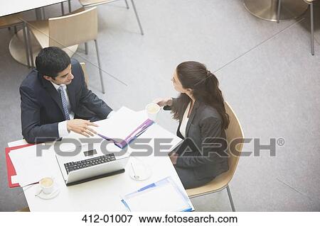 Stock Photo - Businessman and businesswoman meeting in cafe. Fotosearch