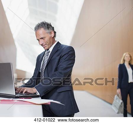 Stock Image - Businessman using laptop. Fotosearch