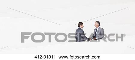 Businessmen shaking hands on modern staircase View Large Photo Image Stock Image - Businessmen shaking hands on modern staircase. Fotosearch