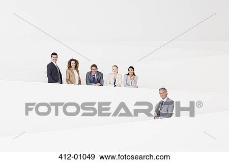 Portrait of confident business people standing on modern stairway View Large Photo Image Stock Photo - Portrait of confident business people standing on modern stairway. Fotosearch