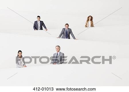 Portrait of smiling business people staggered on modern staircase View Large Photo Image Stock Image - Portrait of smiling business people staggered on modern staircase. Fotosearch