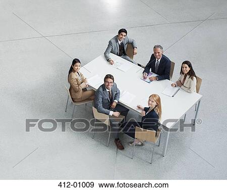 Portrait of smiling business people meeting at table View Large Photo Image Stock Photo - Portrait of smiling business people meeting at table. Fotosearch