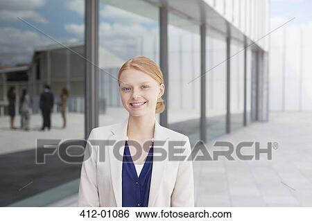 Portrait of smiling businesswoman outside building View Large Photo Image Stock Photograph - Portrait of smiling businesswoman outside building. Fotosearch