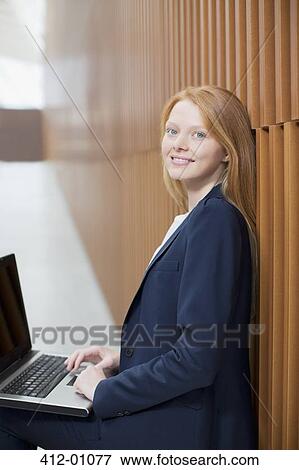 Portrait of smiling businesswoman using laptop View Large Photo Image Stock Photo - Portrait of smiling businesswoman using laptop. Fotosearch