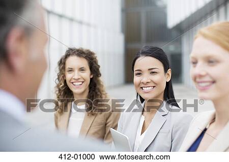 Smiling business people talking View Large Photo Image Stock Image - Smiling business people talking. Fotosearch