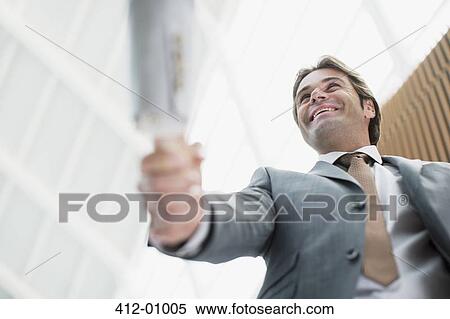 Smiling businessman shaking hands with businesswoman View Large Photo Image Stock Photography - Smiling businessman shaking hands with businesswoman. Fotosearch