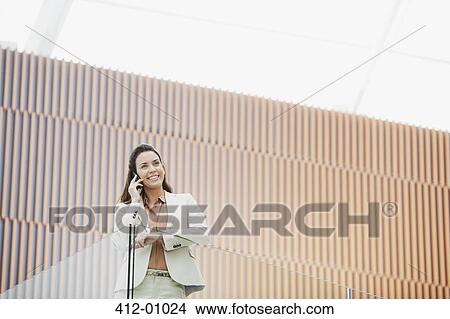 Smiling businesswoman talking on cell phone View Large Photo Image Picture - Smiling businesswoman talking on cell phone. Fotosearch