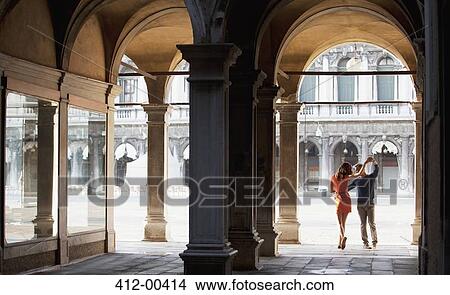 Couple dancing in archway in Venice View Large Photo Image Picture - Couple dancing in archway in Venice. Fotosearch