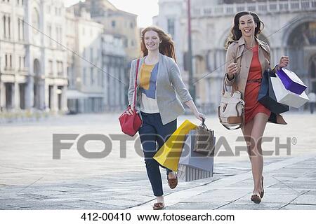 Happy friends with shopping bags running in St. Mark's Square in Venic View Large Photo Image Stock Image - Happy friends with shopping bags running in St. Mark's Square in Venic. Fotosearch