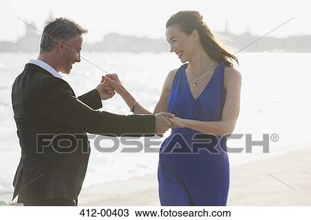 Happy well-dressed couple dancing at waterfront in Venice View Large Photo Image Stock Image - Happy well-dressed couple dancing at waterfront in Venice. Fotosearch