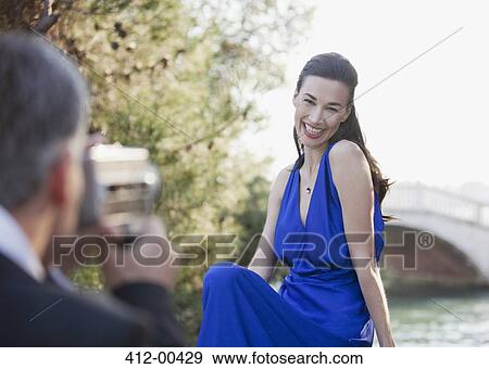 Man filming smiling woman View Large Photo Image Stock Photo - Man filming smiling woman. Fotosearch
