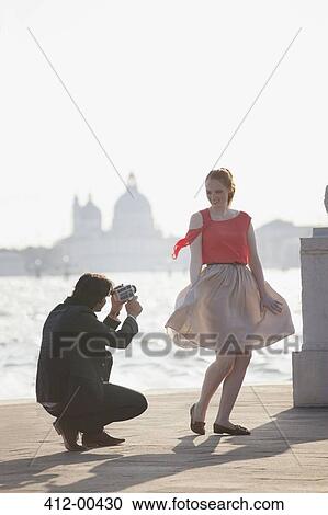 Man videoing smiling woman at waterfront in Venice View Large Photo Image Stock Image - Man videoing smiling woman at waterfront in Venice. Fotosearch
