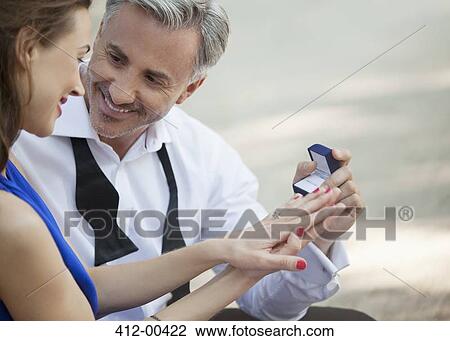 Stock Image - Man with engagement ring proposing to woman. Fotosearch