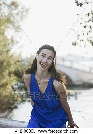 Stock Photography - Portrait of laughing woman with canal in background. Fotosearch