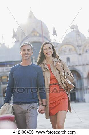 Stock Image - Portrait of smiling couple in St. Mark's Square in Venic. Fotosearch
