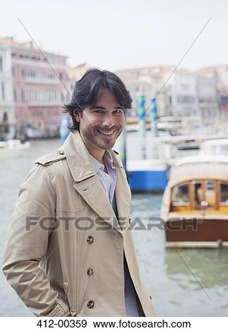 Portrait of smiling man at waterfront in Venice View Large Photo Image Stock Photo - Portrait of smiling man at waterfront in Venice. Fotosearch
