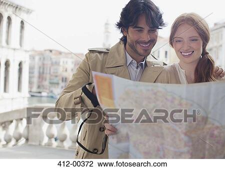 Smiling couple looking down at map in Venice View Large Photo Image Stock Image - Smiling couple looking down at map in Venice. Fotosearch