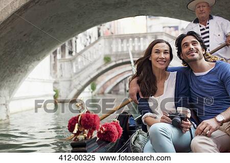 Smiling couple riding in gondola in Venice View Large Photo Image Stock Photography - Smiling couple riding in gondola in Venice. Fotosearch