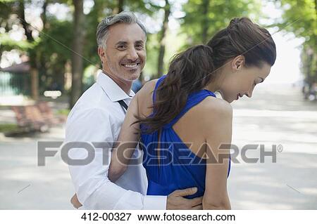 Stock Photo - Smiling couple walking in park. Fotosearch