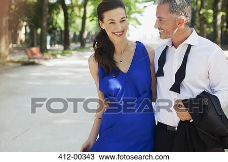 Smiling well-dressed couple in park View Large Photo Image Stock Image - Smiling well-dressed couple in park. Fotosearch
