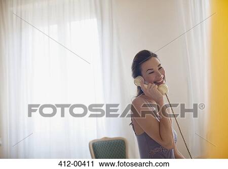 Smiling woman talking on telephone View Large Photo Image Stock Image - Smiling woman talking on telephone. Fotosearch